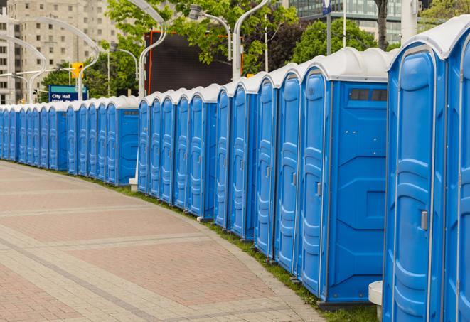 a row of portable restrooms set up for a large athletic event, allowing participants and spectators to easily take care of their needs in Jamaica Plain, MA